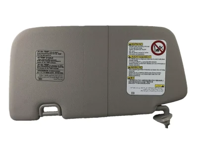 Grey Subaru Impreza sun visor showing mounting bracket, retaining point and warning labels